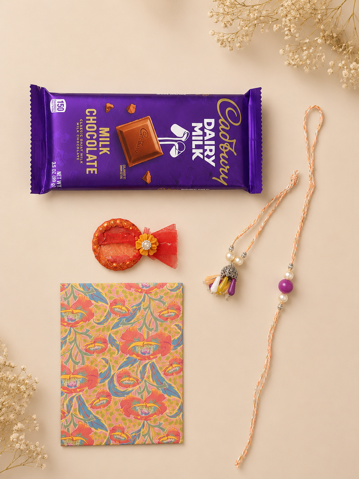 Amethyst Charm Raksha Bandhan gift set with colorful rakhi, lumba, chocolate, greeting card, and roli.
