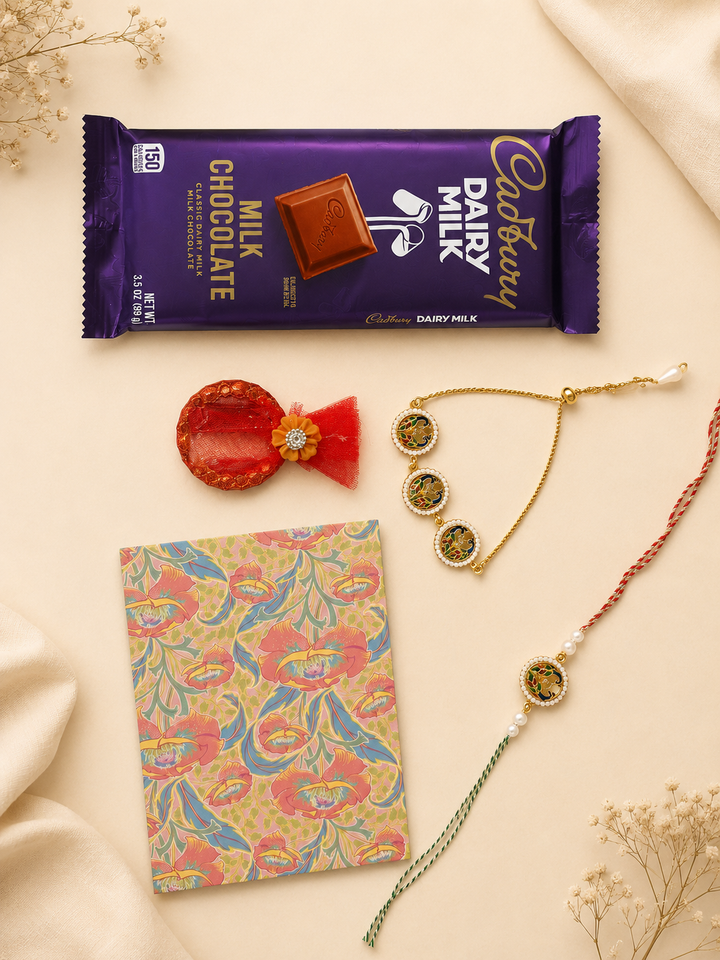 Emerald Heritage Raksha Bandhan gift set with handcrafted rakhi, lumba, chocolate, greeting card, and roli.