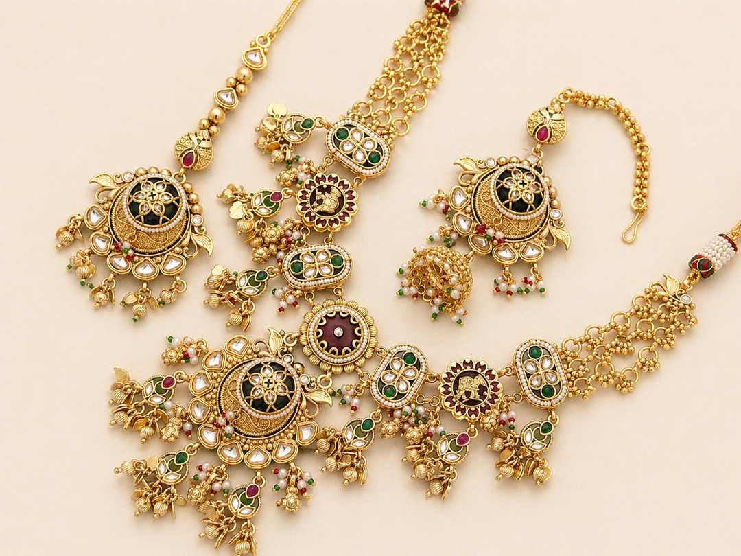 Gold jewelry set with intricate designs on a beige background