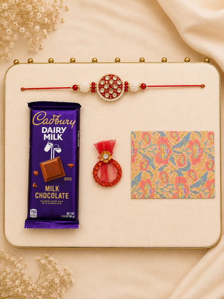 Raksha Bandhan gift box with handcrafted red mosaic rakhi, Cadbury Dairy Milk chocolate, roli and chawal, and illustrated greeting card.
