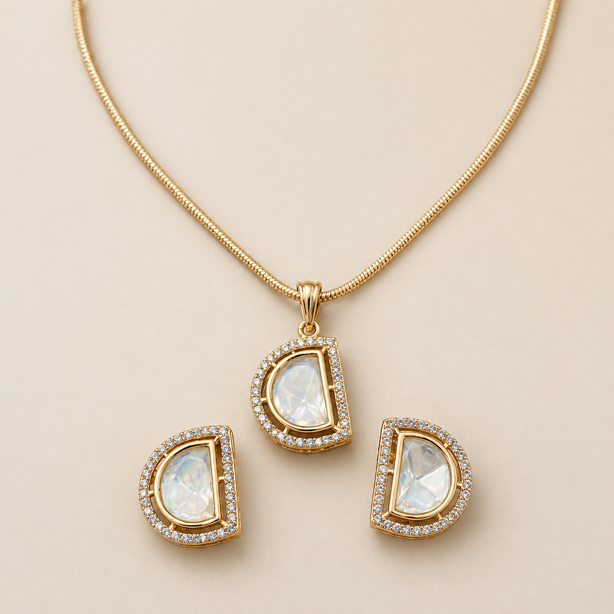 Gold necklace with teardrop-shaped pendants on a beige background