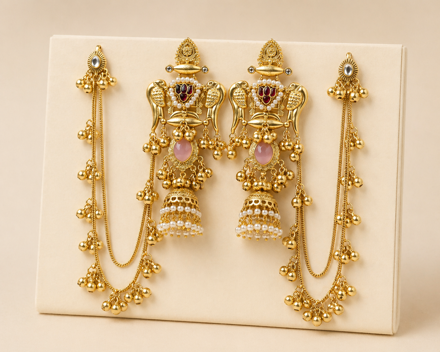 Set of gold earrings on a beige background