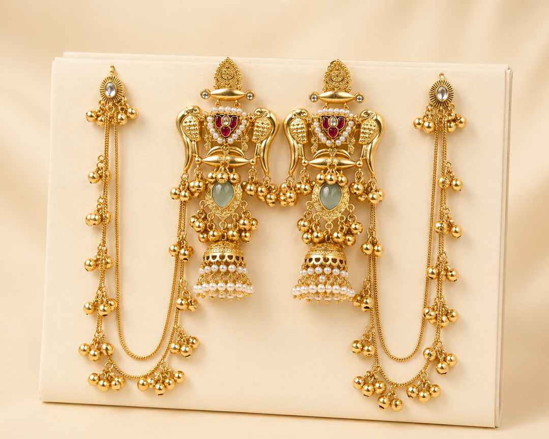 Set of gold earrings on a beige background