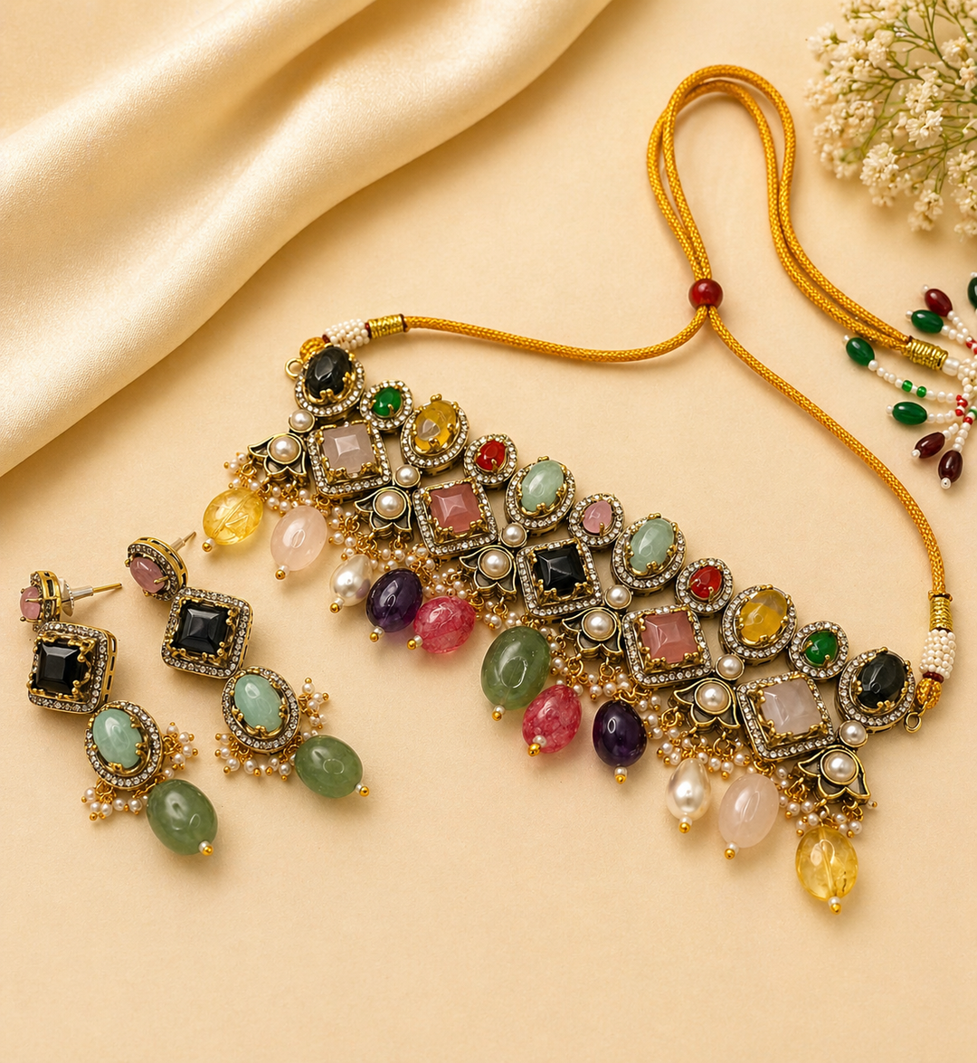 Colorful gemstone necklace and earrings on a beige fabric background