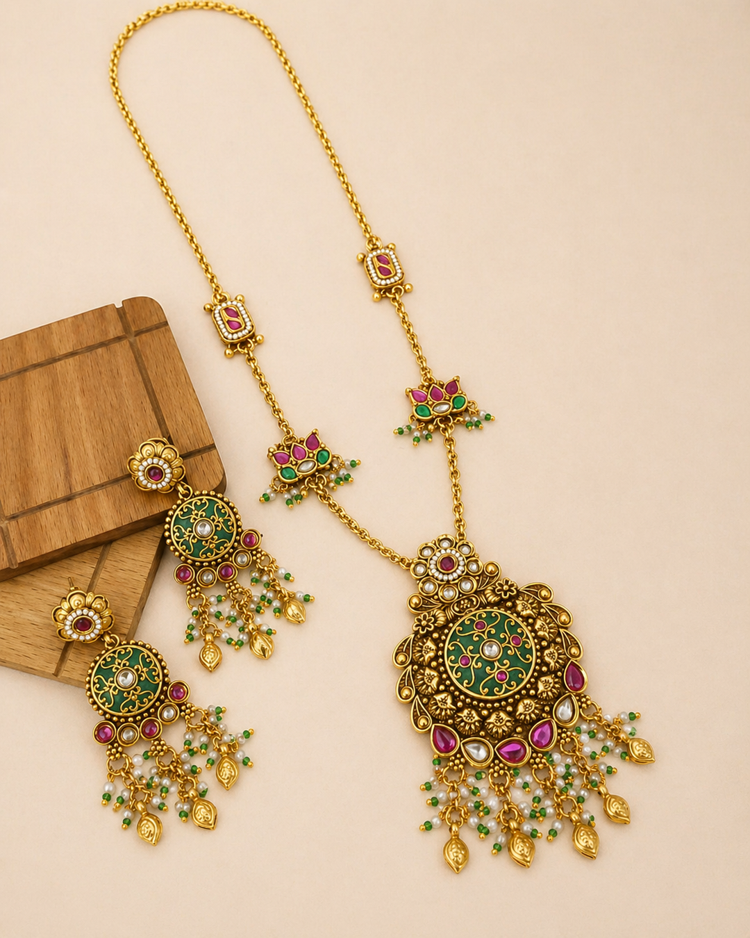 Gold necklace set with earrings on beige background