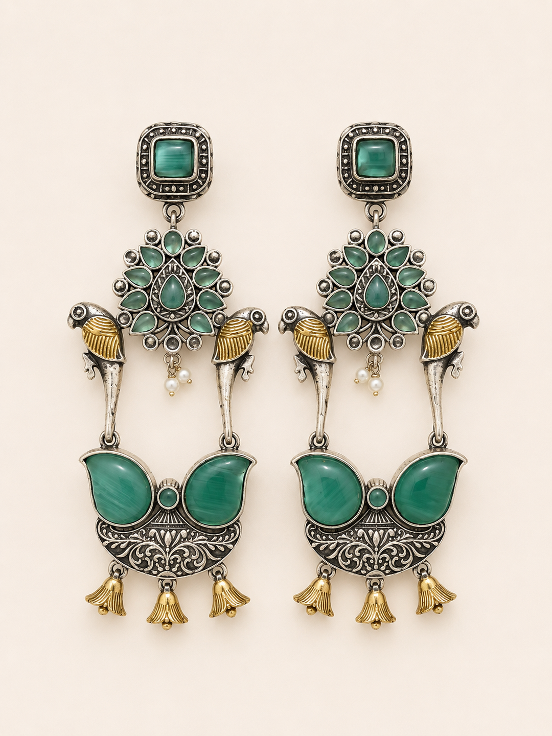 intricate motifs paired with emerald-toned stones and antique silver detailing