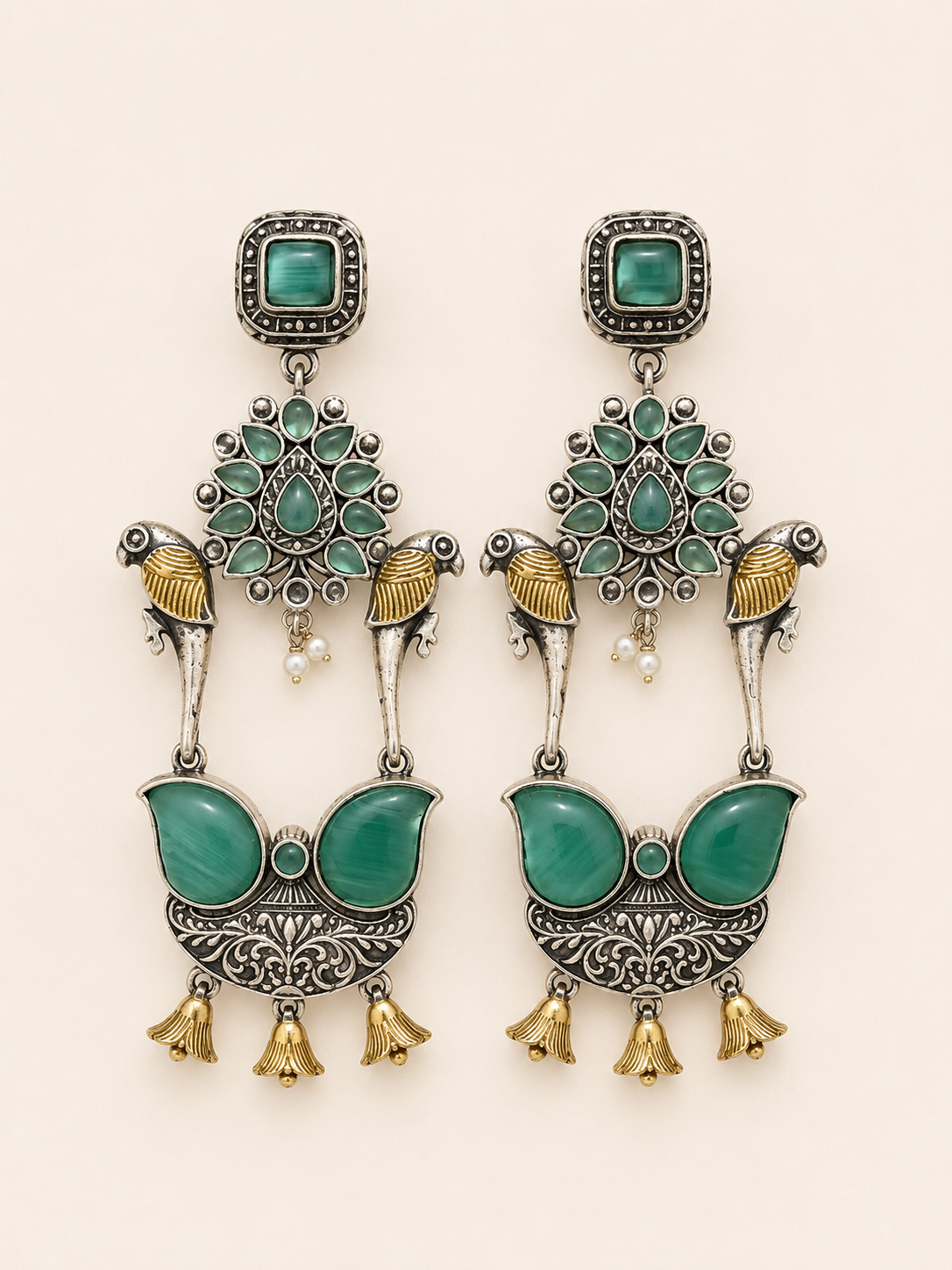 intricate motifs paired with emerald-toned stones and antique silver detailing