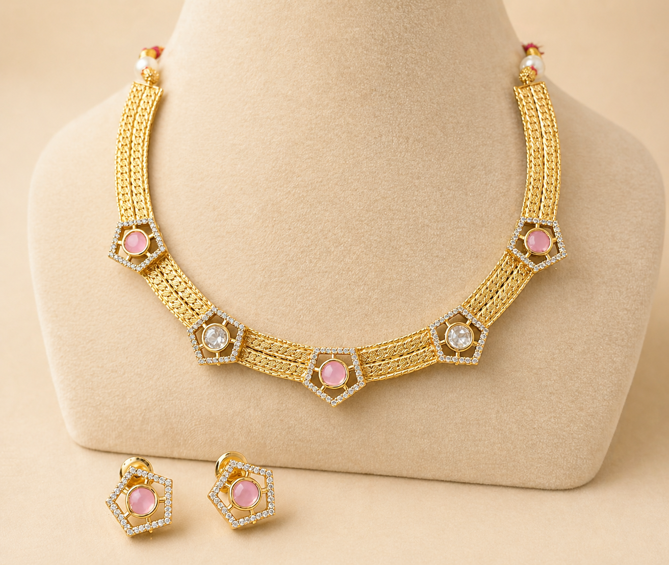 gold set with pink and clear on beige background