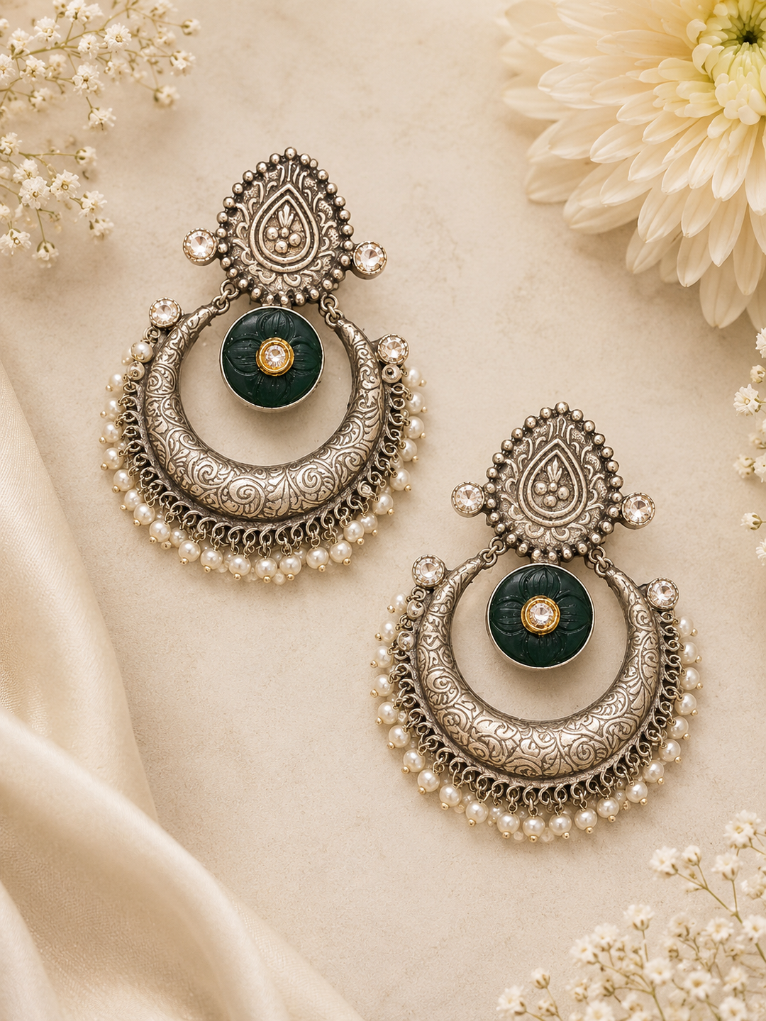 Designed in an oxidized silver finish, these earrings bring a timeless statement to both ethnic and fusion looks.