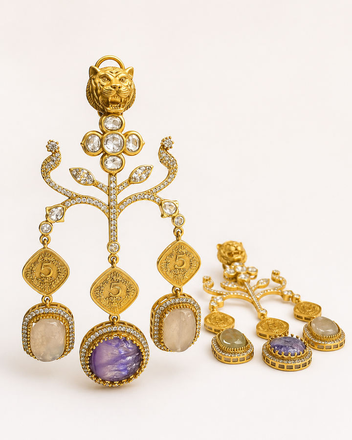 Gold earrings with gemstones on a white background