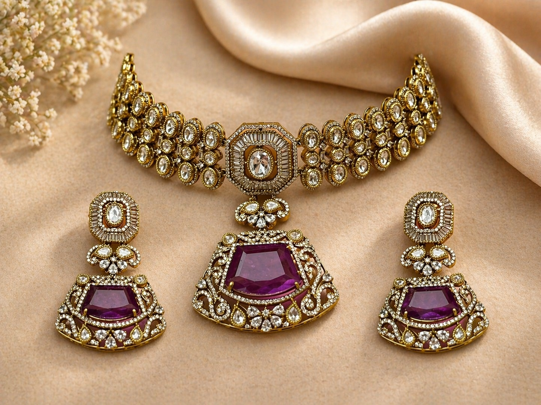 Ornate gold necklace and earrings with purple stones on a beige fabric background