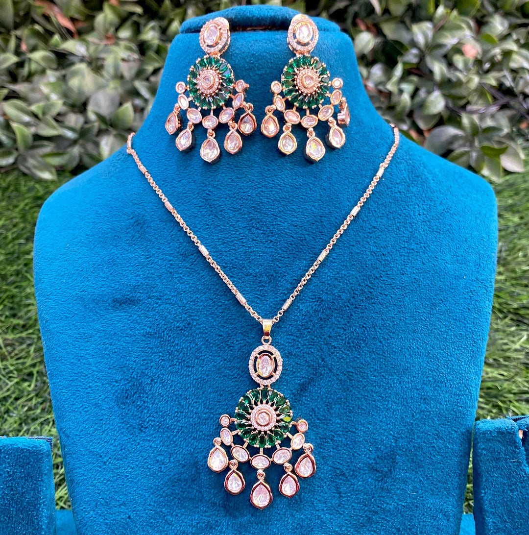 Jewelry set with necklace and earrings on a blue mannequin against a green foliage background